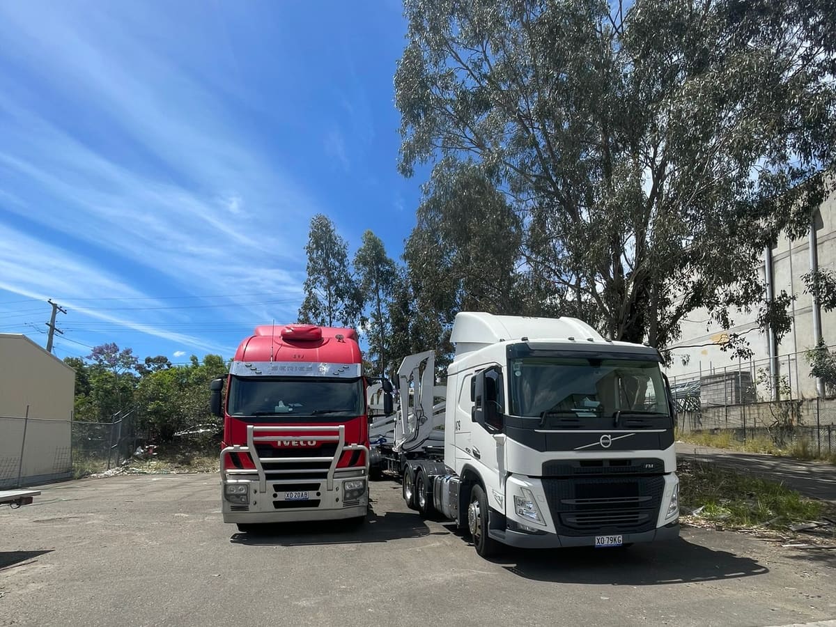 Aardiv prime movers and container trailers parked at a yard in Western Sydney