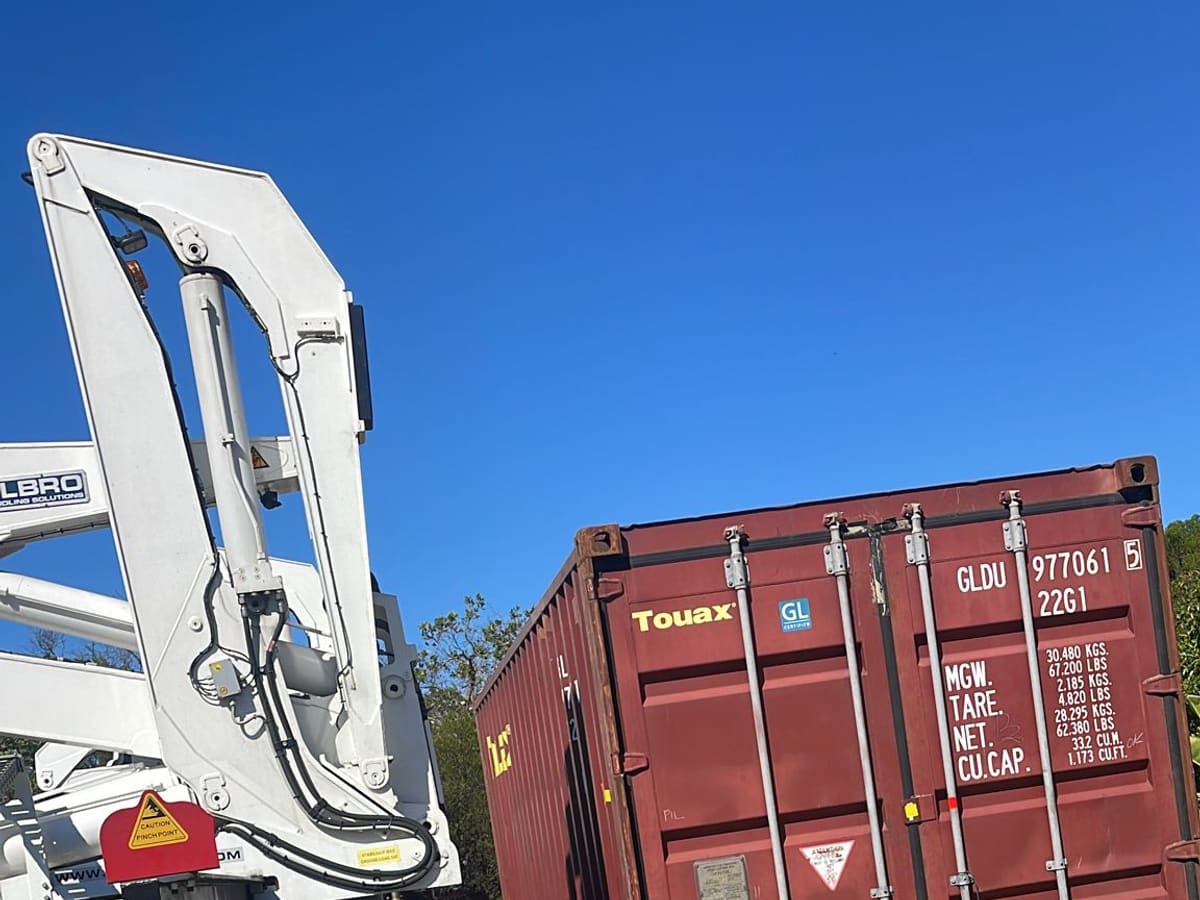 A side loader placing a container at a rural property outside Sydney